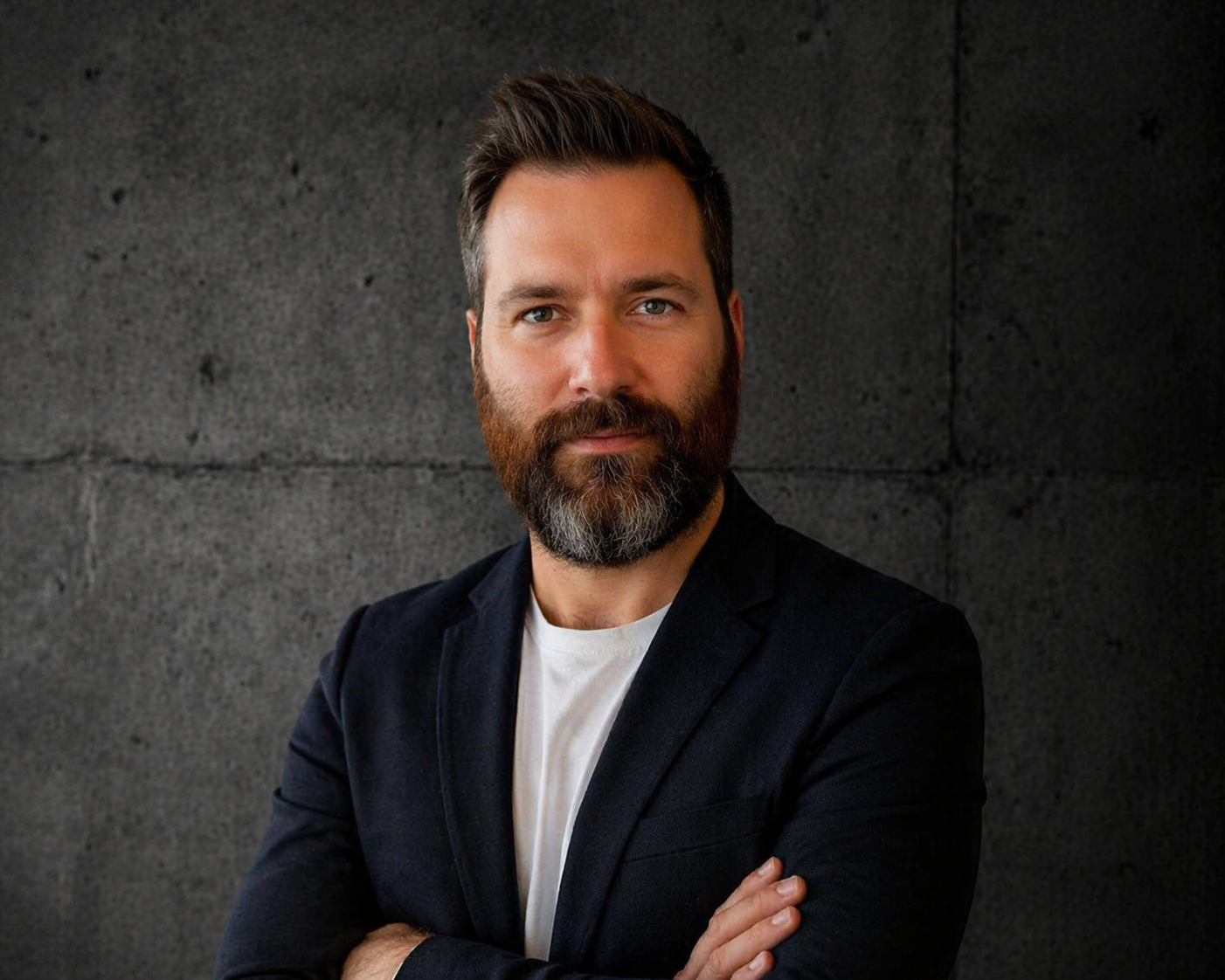 Portrait of Ohad Ben-Gad, founder of Tehomic, against a concrete wall background.
